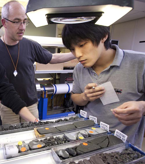 Scientists Michael Stipp and Masaoki Uno choose samples to analyze back at their home institutions.