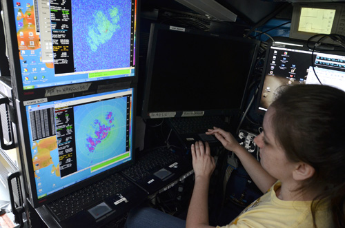 Kayla Flamm, a geography major and atmospheric sciences minor at MU, looks at the radar inside the DOW. The radar is scanning the reflectivity of the clouds, which shows how much moisture the clouds contain.