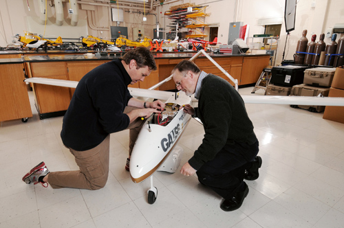 Research engineers Warren Lee (left) and Mike Heiges adjust GTRI’s Airborne Unmanned Sensor System (GAUSS.) (GT Photo by: Gary Meek)