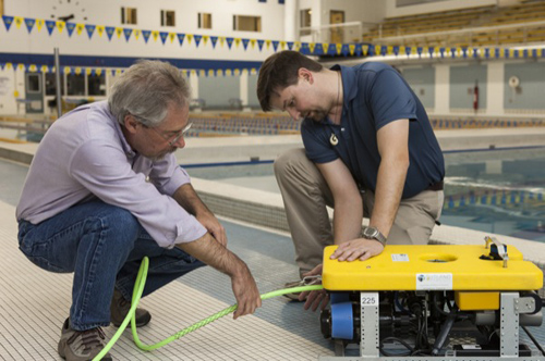 Doug Miller, left, and Arthur Trembanis inspect the new underwater robot. Photos courtesy of Mark Moline and by Ambre Alexander