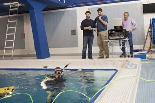 From left, Mark Moline, Carter DuVal, Arthur Trembanis and Doug Miller test a new underwater robot at the Carpenter Sports Building pool. Photos courtesy of Mark Moline and by Ambre Alexander