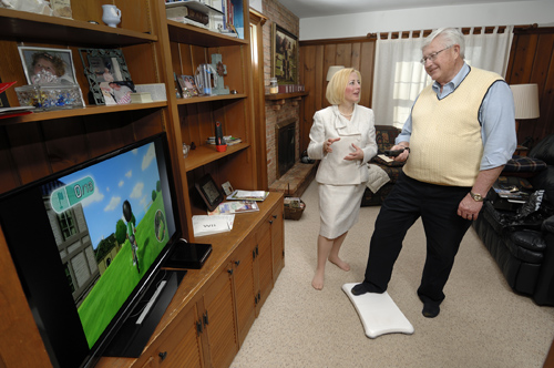 Amy Hoffman, MSU assistant professor of nursing, helps John Cisco exercise using the Nintendo Wii as part of his rehabilitation after surgery for lung cancer. Photo by Harley Seeley.