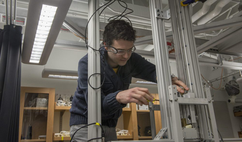 Dustin Kleckner, postdoctoral scientist at the James Franck Institute, adjusts the experimental apparatus that generates knotted vortices in Prof. William Irvine’s laboratory. “We built several different setups until we found one that works really well,” Kleckner said. Photo by Robert Kozloff