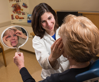 Flora Levin, MD, discusses a blepharoplasty procedure with a patient. Photo by Robert Lisak