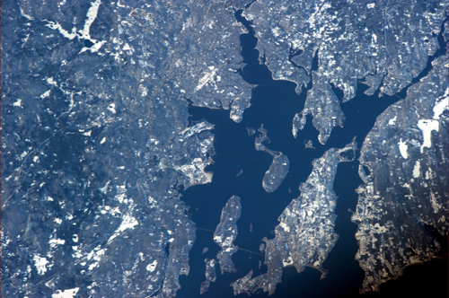 Rhode Island on a clear day. Commander Ford photographed Narragansett and Mt. Hope bays from the International Space Station. His adult kids watched him fly by from the Ladd Observatory, near the top edge of the photo, just right of center. Image credit: Brown University