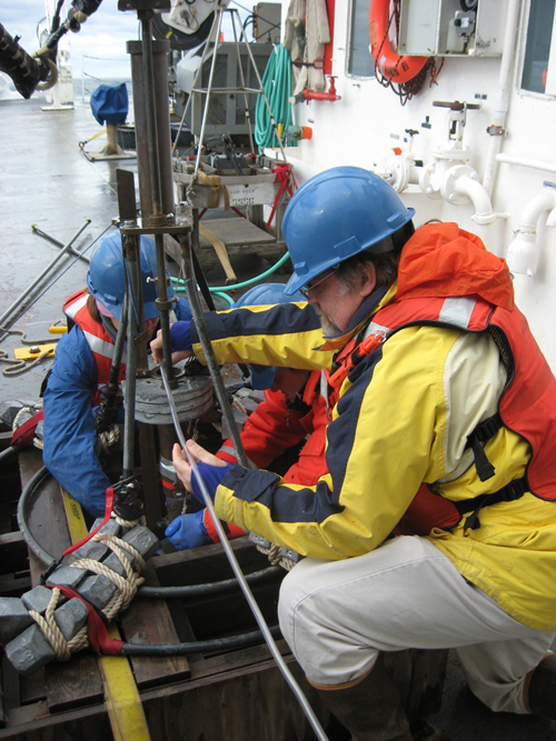 WHOI researcher Bruce Keafer, right, and colleagues prepare a corer to collect sediment samples from the seafloor. They are part of a survey team assembling a regional distribution map of Alexandrium cysts -- the "seeds" or dormant cells of the algae responsible for producing the PSP toxin. The team will analyze the samples to determine the abundance of Alexandrium cysts and, with the help of computer models that simulate different scenarios of weather and oceanographic conditions, develop a forecast of the overall regional abundance of toxic cells expected in 2013. (Photo by Amy Lloyd-Rippe)