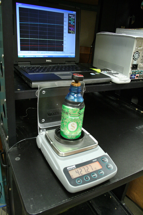 A test subject being weighed to measure the amount of condensation. The cap prevents air from moving through the opening on top. Image credit: Univ. of Washington