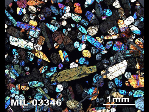 A microscopic image of a slice of a meteorite. The various colors indicate the sizes, shapes and orientations of minerals in the rock. Image courtesy of NASA.