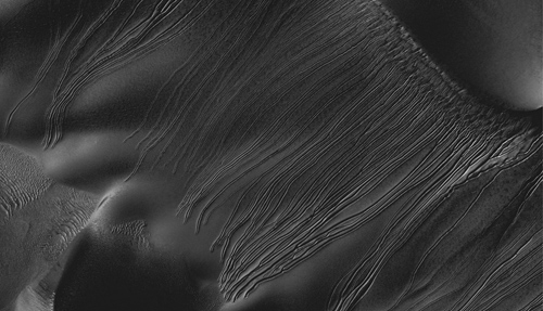 Several types of downhill flow features have been observed on Mars. This image from the High Resolution Imaging Science Experiment (HiRISE) camera on NASA's Mars Reconnaissance Orbiter is an example of a type called "linear gullies." Image credit: NASA/JPL-Caltech/Univ. of Arizona