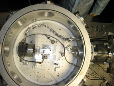 The interior of the vacuum chamber in which the acceleration occurs. The laser beam arrives from the right. The gas cell, within which the acceleration of electrons occurs, is in the center of the chamber. The actual acceleration occurs over a distance of about an inch. Image credit: Courtesy of Neil Fazel