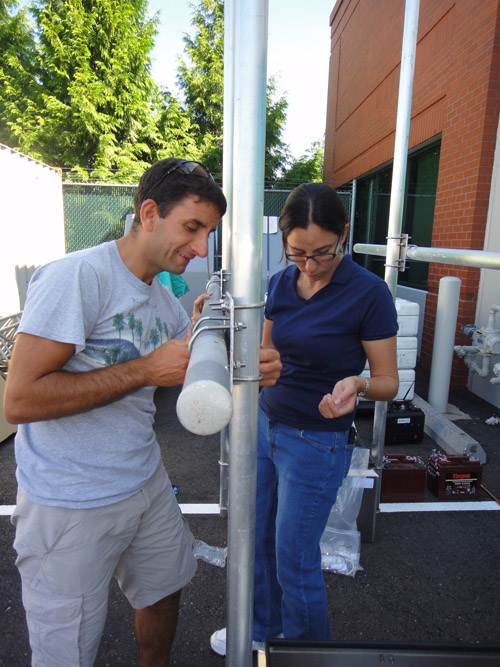 Domenico Mangione (Italy) and Celina Kattan (El Salvador) assemble the framework of a telemetry station in the parking lot of the USGS Cascades Volcano Observatory. Image credit: U.S. Geological Survey