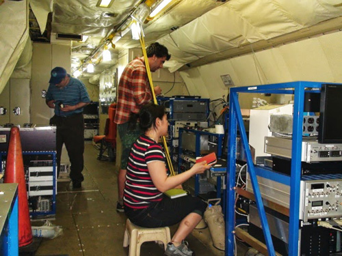 UW graduate student Felipe Lopez-Hilfiker (center) and postdoctoral researcher Ben Lee (not shown) are taking measurements in a P-3 aircraft. UW postdoctoral researcher Claudia Mohr is operating ground-based equipment. Image credit: University of Washington