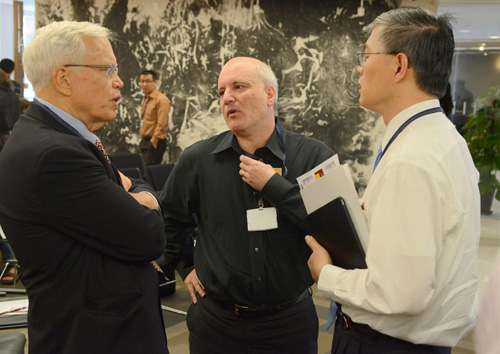 Professors James Heckman (left to right), Steven Durlauf and Dali Yang talk during a break in the Conference on the Study of Inequality. Photo by James Withrow