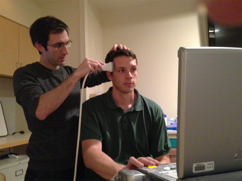 Jay Sanguinetti, a doctoral candidate the UA's department of psychology, administers brain ultrasound during a clinical trial. (Image courtesy of Jay Sanguinettii)
