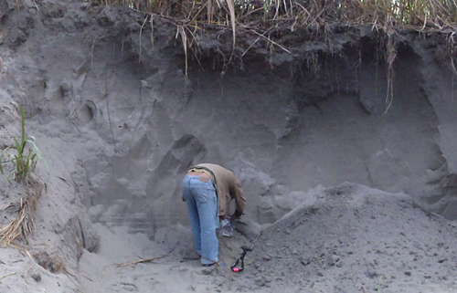 During a 2011 field trip, a regional assistant gathers samples from a deposit left by a catastrophic flood on the Yarlang-Tsangpo River in 2000. Image credit: Karl Lang/UW