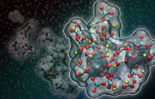 Artistic rendition of liquid-liquid separation in a supersaturated calcium carbonate solution. New research suggests that a dense liquid phase (shown in red in the background and in full atomistic detail based on computer simulations in the foreground) forms at the onset of calcium carbonate crystallization. (Image credit: Berkeley Lab)
