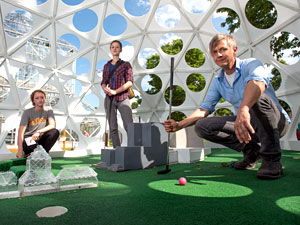 Professor Chris Larson, with students Jordan Rosenow (left) and Sara Nichol (center) in their sculpture, "Mega Golf." Image credit: University of Minnesota