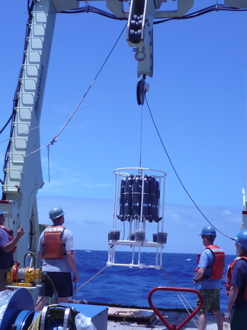 Aboard the R/V Knorr, WHOI researchers Carl Lamborg, Tyler Goepfert, and Chad Hammerschmidt deploy a trace metal rosette on five kilometers of non-metallic line to gather samples of seawater from the depths of the South Atlantic Ocean. (Photo courtesy Emily Nahas, Univ. of Washington)