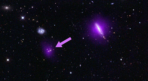 An optical color image of galaxies is seen here overlaid with X-ray data (magenta) from NASA's Nuclear Spectroscopic Telescope Array (NuSTAR). Image credit: NASA/JPL-Caltech