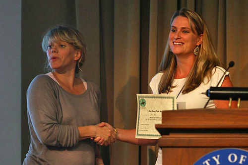 Inga Wolframm (left), who coordinated the 2013 ISES Student Oral Presentation and Poster Competition, honors Jessica Weir. Photo by Danielle Quigley