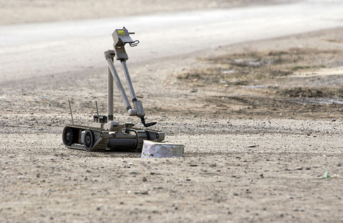 A United States Army explosive ordnance disposal robot pulls the wire of a suspected improvised explosive device in Iraq. Image credit: U.S. Navy photo by Journalist 1st Class Jeremy L. Wood. (Image source: Wikipedia) 