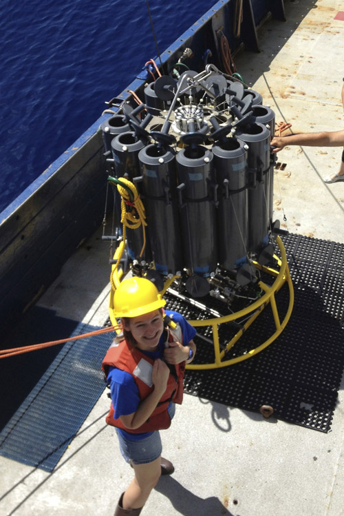 Sarah Schwenck prepares to deploy the rosette, which contains bottles on a metal frame that the research team then lower into the ocean on a cable to collect water samples from different depths. (Photo credit: Jennifer Glass, Georgia Institute of Technology)