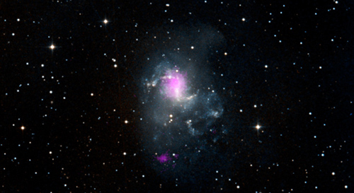 The magenta spots in this image show two black holes in the spiral galaxy called NGC 1313, or the Topsy Turvy galaxy. Both black holes belong to a class called ultraluminous X-ray sources, or ULXs. The magenta X-ray data come from NASA's Nuclear Spectroscopic Telescopic Array, and are overlaid on a visible image from the Digitized Sky Survey. Image credit: NASA/JPL-Caltech/IRAP
