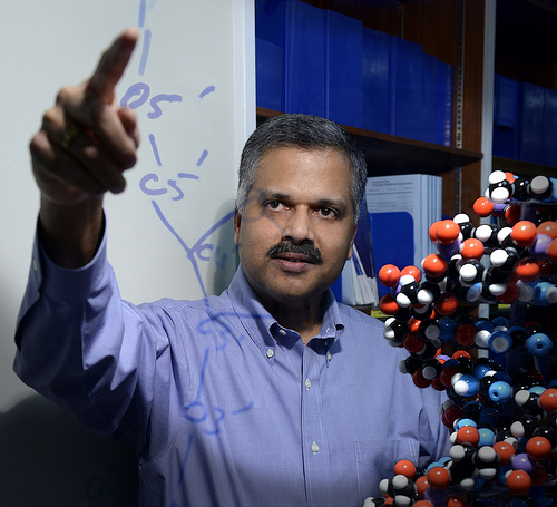 Director of Computational Biology Ajay Royyuru points to a drawing of the chemical formula for DNA at IBM Research headquarters in Yorktown Heights, NY, Tuesday, December 17, 2013. In five years, cloud-based cognitive computers will routinely help doctors use DNA data to provide effective, tailored oncology treatments. The advanced systems will cull through medical literature, clinical records and genomic information to present a set of medications shown to best attack the individual patient's cancer cells, making personalized medicine available at a scale and speed never before possible. (Image credit: Jon Simon/Feature Photo Service for IBM)
