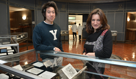 Professor Paola Bertucci and Cyrus Nguyen '15 at the exhibit "Books of Secrets: Alchemy, Medicine, and Magic" that her students curated as part of their midterm assignment for her seminar. (Photo by Michael Marsland)