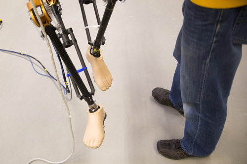 Brian Buss, Electrical Systems Engineering PhD Student, readjusts the legs of MARLO, a bipedal robot, in a lab located in the Environmental and Water Resources Engineering Building on November 19, 2013. Image credit: Joseph Xu