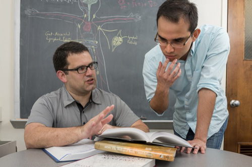 Ryan Zurakowski (left), shown with doctoral student Fabian Cardozo, is co-author of a paper appearing in Nature Medicine highlighting the role of T-cells in HIV. Photo by Kathy F. Atkinson