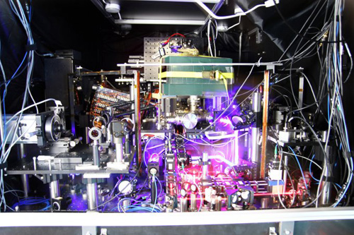 JILA’s experimental atomic clock based on strontium atoms held in a lattice of laser light is the world's most precise and stable atomic clock. This image is a composite of many photos taken with long exposure times and other techniques to make the lasers more visible. (Image credit: Ye group and Brad Baxley/JILA) 