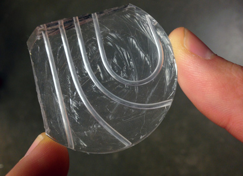 This prototype of a microfluidic device has both curved and straight channels for transporting tissue biopsies. The silicon material is lightweight, flexible and transparent. Image credit: U of Washington