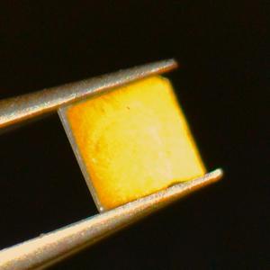 The first thin films of spin ice. The orange colouration is a spin ice film of only a few billionths of a meter thickness. Image credit: University College London