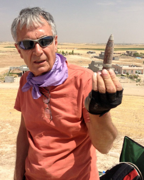 Abbas Alizadeh, senior research associate at the Oriental Institute, holds a piece of spent ammunition from the top of the mound of Surezha. The mound, located in the Erbil province of northern Iraq, had been used as an antiaircraft emplacement during the Iran-Iraq war. Image courtesy of Gil Stein/Oriental Institute