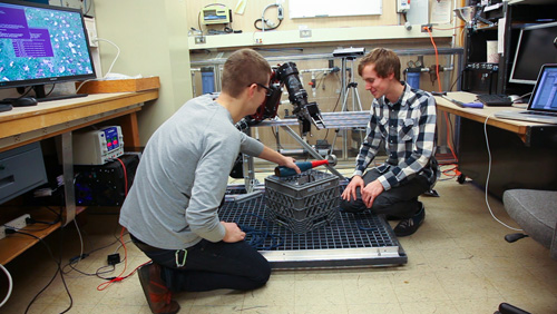 Undergraduates students Derek Martin, left, and Ryan Cox work on instrumentation with the BluHaptics team. Image credit: Conrado Tapado, UW