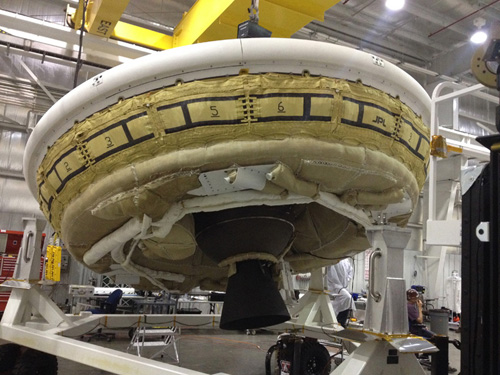 A saucer-shaped test vehicle holding equipment for landing large payloads on Mars is shown in the Missile Assembly Building at the US Navy's Pacific Missile Range Facility in Kaua'i, Hawaii. Image Credit: NASA/JPL-Caltech