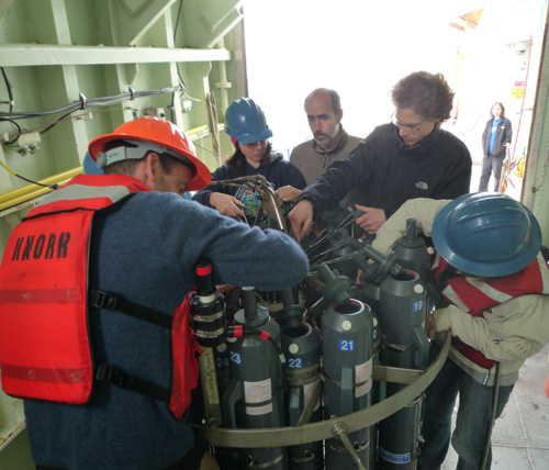 The study's lead author Patrick Martin (second from right) and WHOI marine chemist Ben Van Mooy (left) with their colleagues working around a water sampling rosette. (Photo courtesy of Ben Van Mooy, Woods Hole Oceanographic Institution)