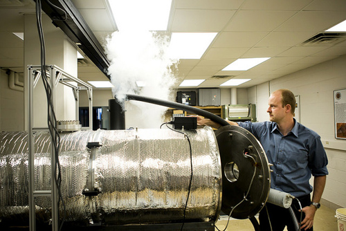 Erik Fischer, AERO PhD Student and AOSS Researcher, sets up a Mars Atmospheric Chamber by running liquid nitrogen to cool down the chamber in the Space Research Building. Image credit: Joseph Xu