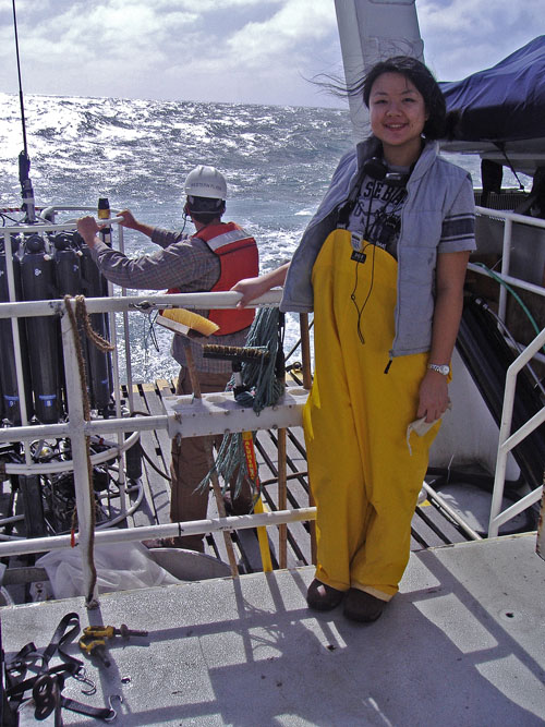 Li Deng, co-first author on the Nature paper, stands on the deck of the research vessel "Western Flyer" in front of the sampling device used to measure salinity, temperature and depth of the ocean during sample collection. (Photo credit: Sullivan lab)