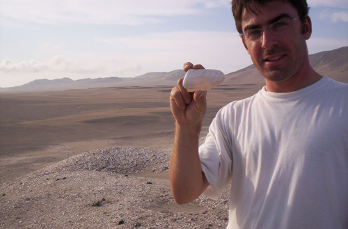 Matthieu Carré holds a 6,800-year-old mollusk collected from a site in Peru’s Ica valley. The shells record the temperature of the ocean during their 1- to 3-year lifetime. Image credit: M. Carre / Univ. of Montpellier