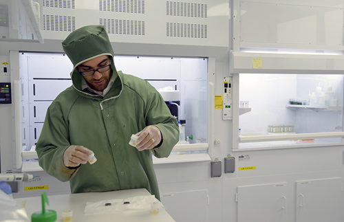 Adam Sarafian, lead author of the paper and a MIT/WHOI Joint Program student in the WHOI Geology and Geophysics Department, preps samples in Sune Nielsen's NIRVANA clean lab to remove all contamination from the surface prior to analysis. (Photo by Jayne Doucette, Woods Hole Oceanographic Institution)