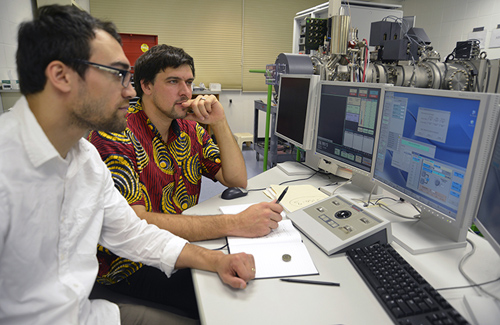 Geologists Adam Sarafian (left) and Horst Marschall working in the Northeast National Ion Microprobe Facility.(Photo by Jayne Doucette, Woods Hole Oceanographic Institution)