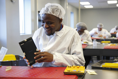 Operator Salah Macheremo, a native of Kenya, in the BAK USA clean room in Buffalo, New York. Photo credit: Microsoft