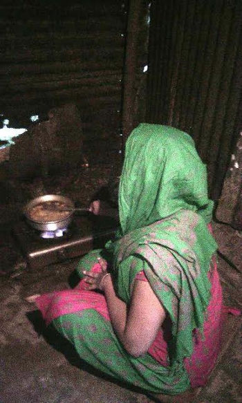 Chandra cooks her food at kitchen. Photo credit: Kayes Sohel