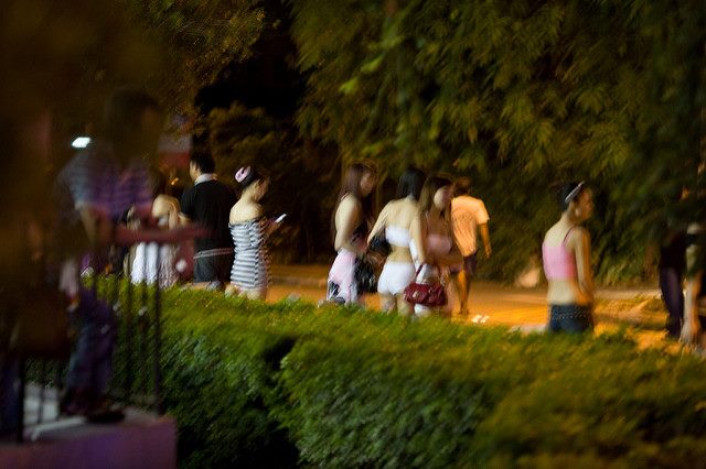 Prostitutes line up, waiting for clients in Singapore Red Light District. Photo credit: David Sifry (Source: Flickr)