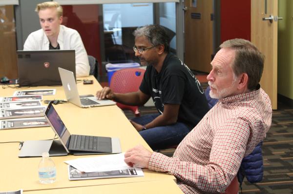 University of Utah honors and law professor (lecturer) Randy Dryer, right, and University of Utah School of Computing associate professor Suresh Venkatasubramanian, center, teach an honors class on how software algorithms used in judicial courts to evaluate defendants could be biased like humans. The class has created a mobile game called Justice.exe that teaches the player how such algorithms could be flawed. PHOTO CREDIT: University of Utah