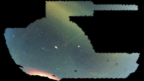 This image shows the entire Dark Energy Survey field of view – roughly one-eighth of the sky – captured by the Dark Energy Camera, with different colors corresponding to the distance of stars. (Blue is closer, green is farther away, red is even farther.) Several stellar streams are visible in this image as yellow, blue and red streaks across the sky. Image courtesy of Dark Energy Survey 