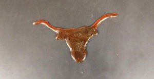 UT engineers show off their school spirit by molding the new, sustainably produced plastic material into a Longhorn silhouette in Hal Alper’s lab. Image credit: Cockrell School of Engineering